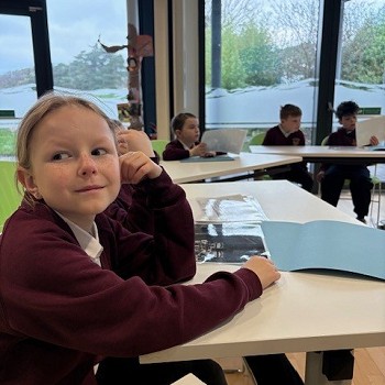 girl sitting at a white desk