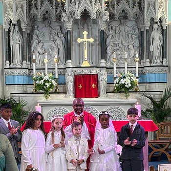 Blessed William Davies Catholic Primary School pupils celebrating their First Holy Communion 2025 standing at the alter