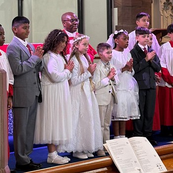 Blessed William Davies Catholic Primary School pupils celebrating their First Holy Communion 2025 in church.