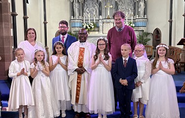 group on the stage for the First Holy Communion