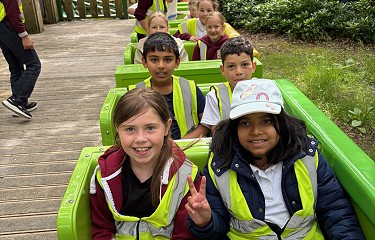 group of students sitting on a rollercoaster