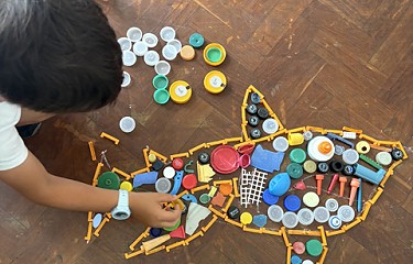 a student making a shark out of different objects