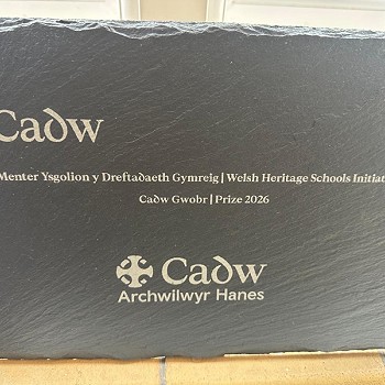 slate with cadw logo on it