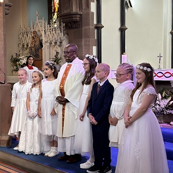 group on the stage for the First Holy Communion